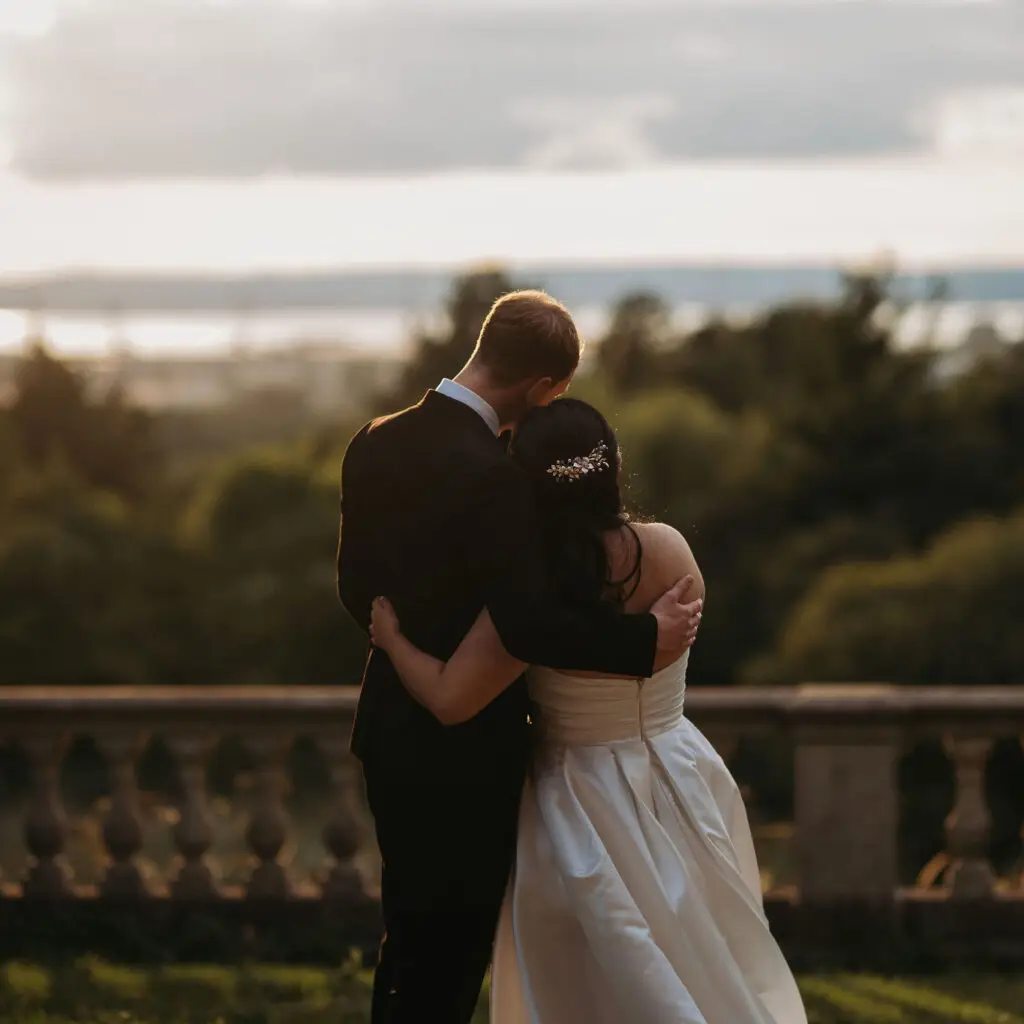 A wedding couple looking at the view over the Bristol Channel.